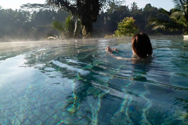 istock A young woman relaxing in a luxurious infinity pool 1179678045