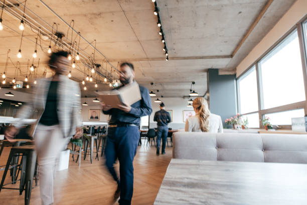 Colleagues having a coffee break in a modern office building in Paris, France