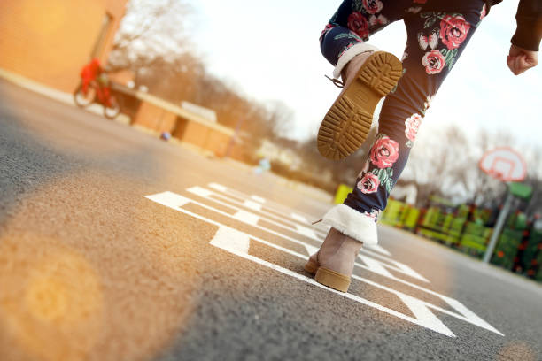 girl in beautiful boots playing hopscotch on playground outdoors - 7070 imagens e fotografias de stock
