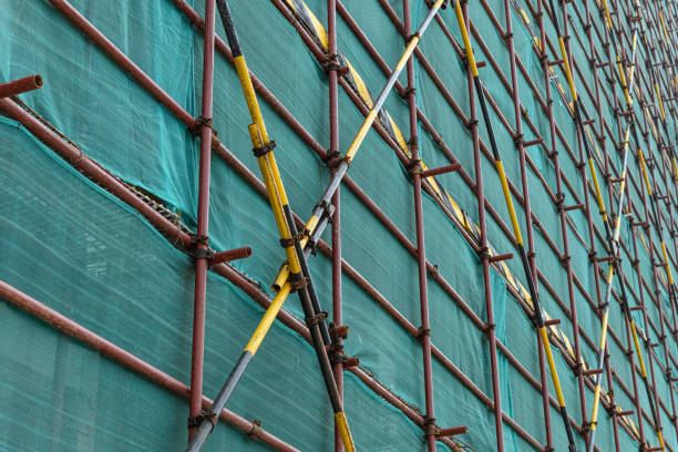 istock scaffolding and protection netting on an unfinished building 1179680205