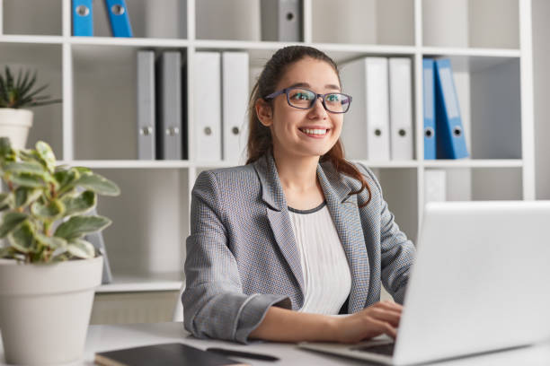 istock Cheerful woman working in office 1179680334