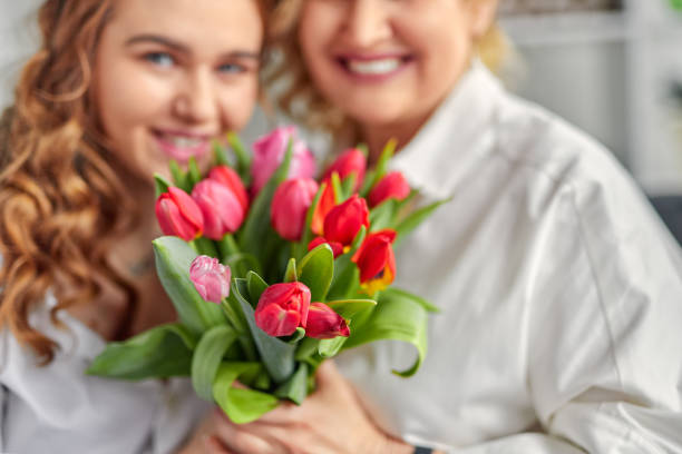istock Mother and daughter with bright bouquet 1179680366