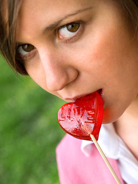 istock Woman with heart-shaped lollypop 117968141