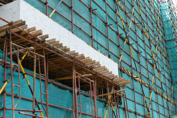 istock scaffolding and protection netting on an unfinished building 1179683167
