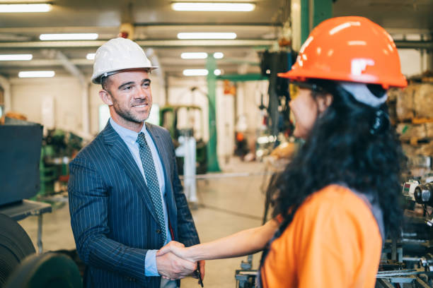 istock Manager in handshake with new worker in factory 1179683205