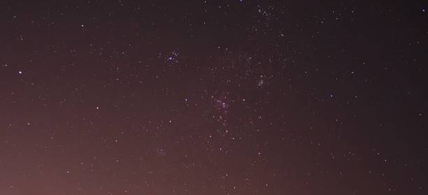 istock Colorful stars on reddish sky 1179686291