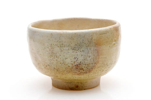 Single tea bowl used in Japanese matcha tea ceremony on white hackgrond