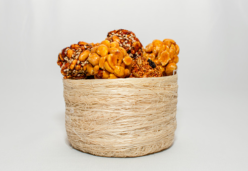 basket with a bunch of typical mexican seeds candies nuts peanuts honey amaranth in circle white background isolated
