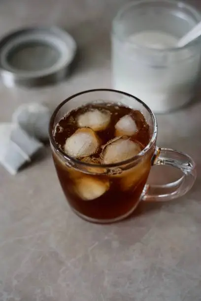 Homemade Iced-Tea with bowl of sugar and tea bags in the background