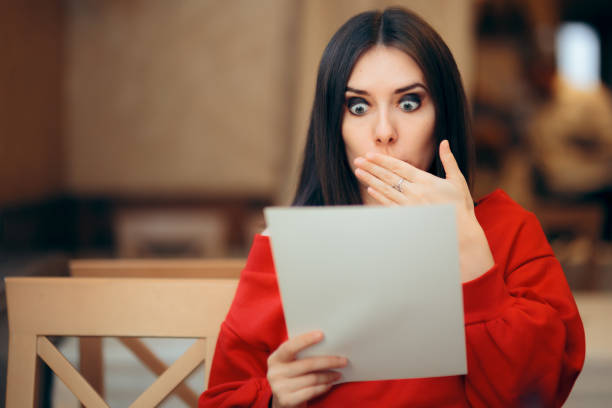 istock Surprised Woman Reading Legal Documents in a Restaurant 1179691786