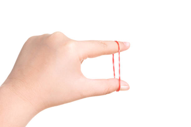 istock Child hand playing with elastic rubber band isolated on white 1179692115