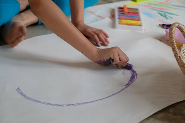 istock Preschoolers are practicing coloring on white paper. 1179694644