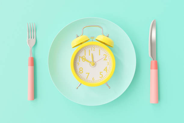 istock Yellow clock on the blue-green plate 1179694888