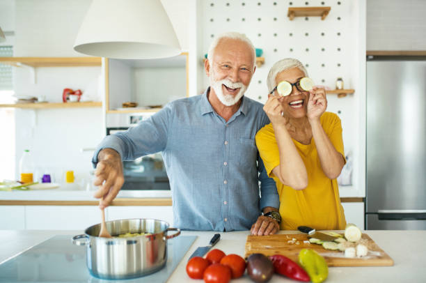 istock Mature couple having fun while cooking lunch. 1179695777