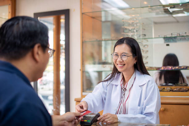 istock happy customer making payment using credit card in a eyewear store 1179709409