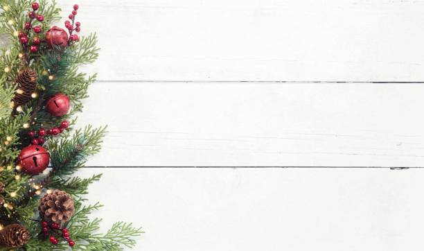 Photo of Christmas pine garland border on an old white wood background