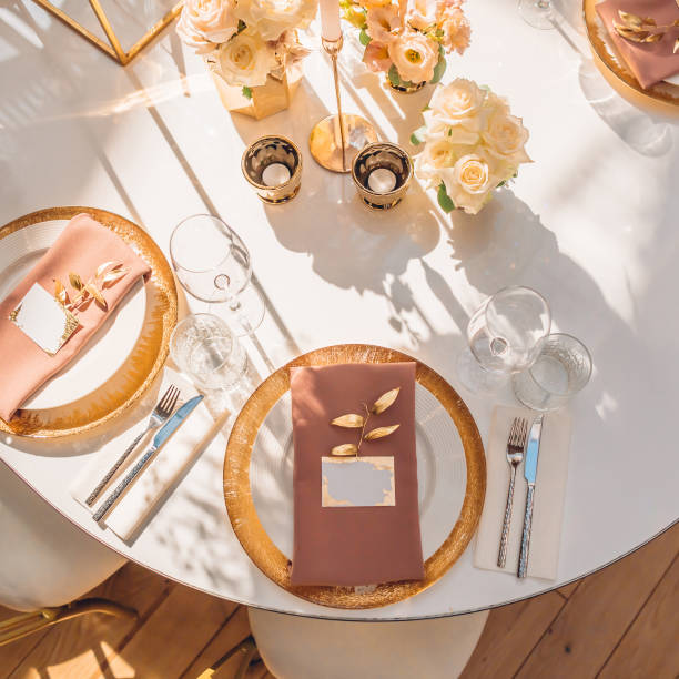 istock Served table at a wedding party. Warm sunlight on the festive table. 1179714494