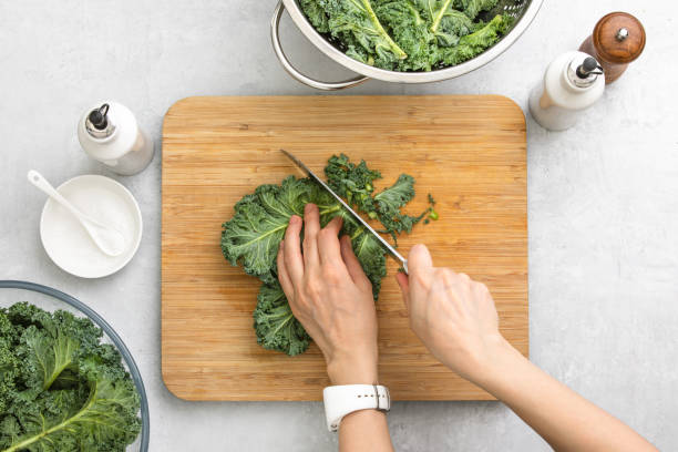 Top down view of fresh kale leaves cut on a cutting board stock photo