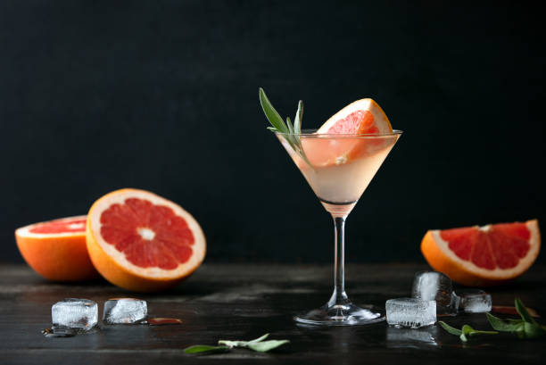 Sage and pink grapefruit gimlet, front view Sage and pink grapefruit blush gimlet, front view, blank space for a text cocktail party photos stock pictures, royalty-free photos & images