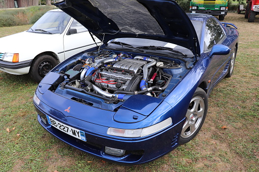 Mitsubishi 3000 GT 24B Bi Turbo - Sports car with 2 seats - Blue color - Year 1993 - Motor show in the town of Mornant - Rhone department on October 6, 2019 - View from the motor in front of the vehicle