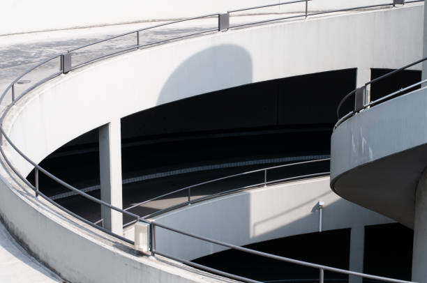 entrance to underground parking lot in a city, spiral concrete ramp, urban architecture