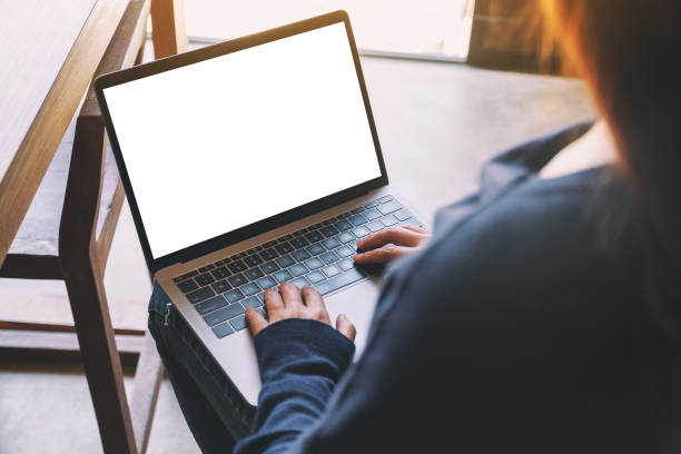istock a woman using and typing on laptop computer keyboard with blank white desktop screen 1179722072