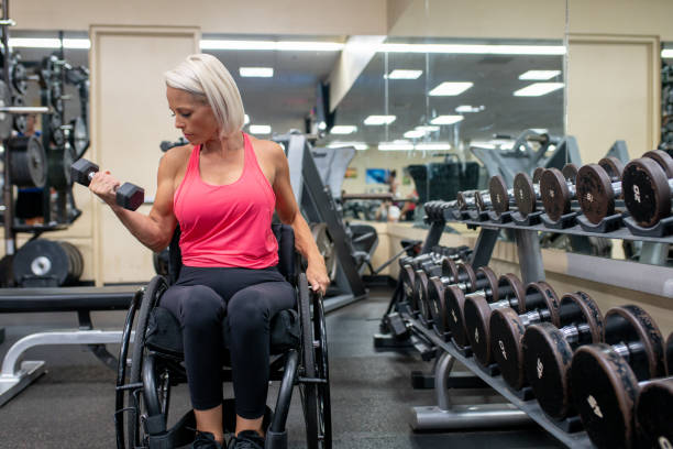 istock Adaptive athlete in a wheelchair lifting weights 1179727059