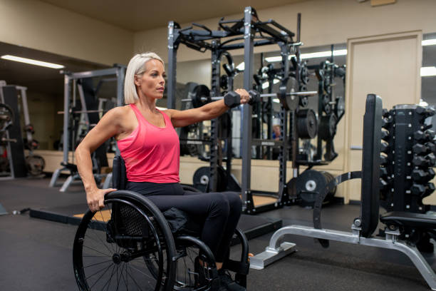 istock Adaptive athlete in a wheelchair lifting weights 1179727063