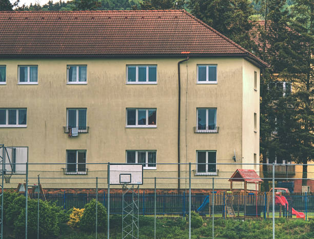 istock Cheap flats windows in  storey house in small town. Low cost 1179729706