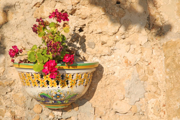 Hand painted flower pot hanging to a grunge wall
