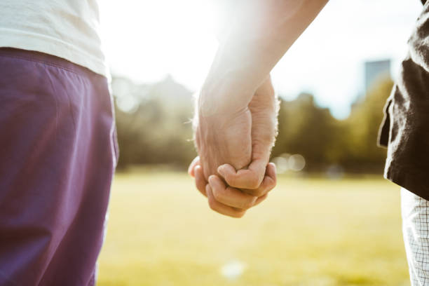 istock gay couple holding hands 1179729789