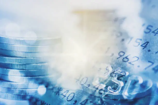 Photo of double exposure of coins and book bank with credit card for finance and business concept