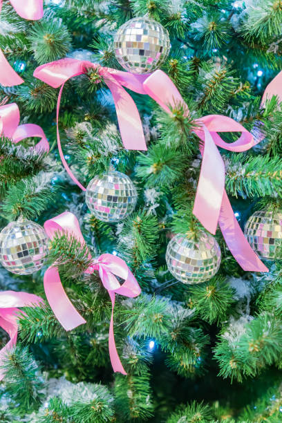 istock Christmas and New Year holidays background. Christmas tree decorated with silver disko balls, bows and garlands. Glittering and sparkling. Celebration concept 1179730346