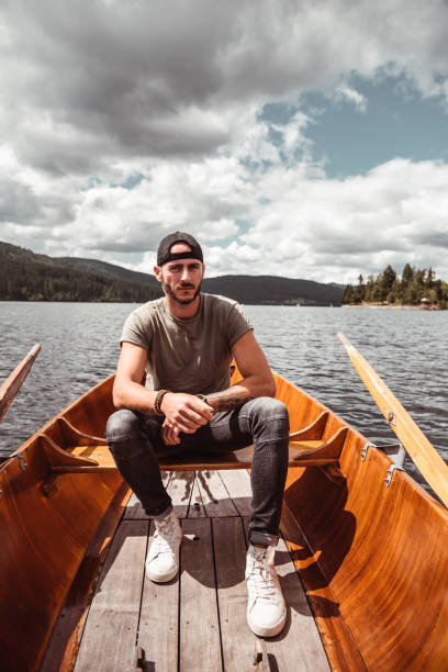 istock man sitting on the canoe 1179731320