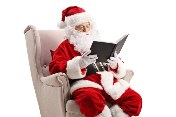 istock Santa Claus in an armchair and reading a book 1179732616