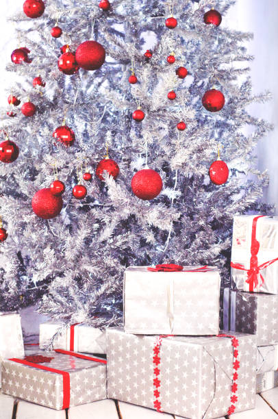 istock Silver Christmas tree with gifts with red bows. 1179733833