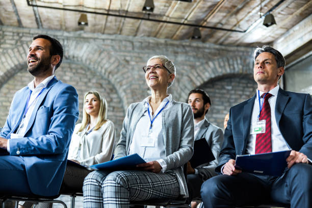 istock Below view of happy entrepreneurs having training class in board room. 1179734415
