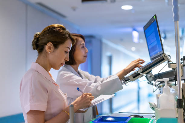 istock Nurse assisting doctor in analyzing medical records 1179734536