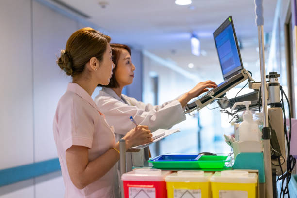 istock Nurse looking at doctor using computer in hospital 1179734540