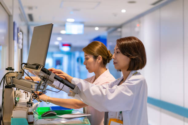 Doctor and nurse working on computer in hospital