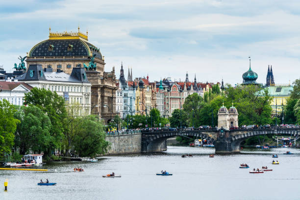 View from Charles Bridge, The  clorful buildings along the bank of Vltava river with National Theatre in Prague city,  the Vltava river is the logest river in Czech. stock photo