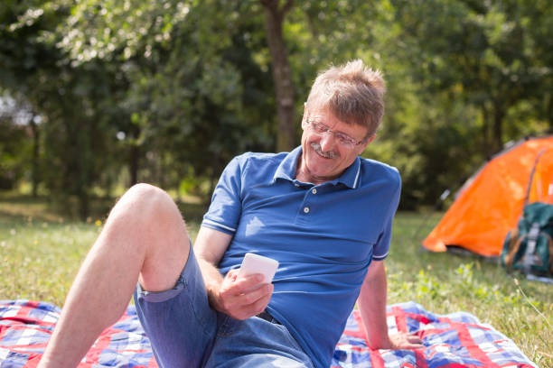 istock Happy mature man looking at phone 1179736919