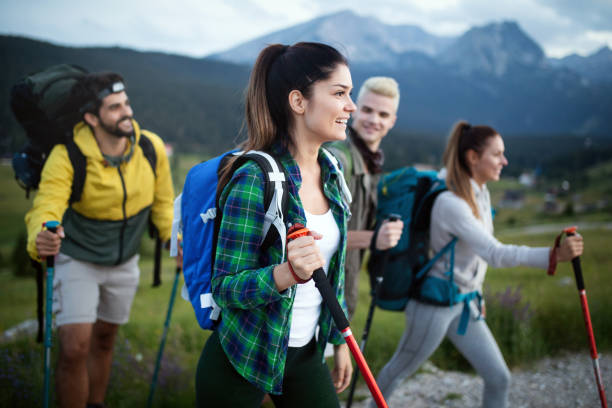 istock Four happy friends are looking on mountains and having fun together 1179737636