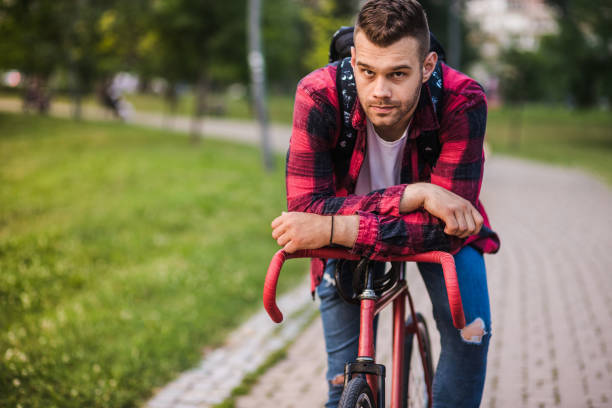istock Man sitting on his bicycle in the park 1179738232