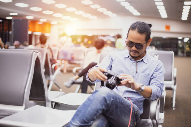 istock Asian man with backpack  traveler using the smart mobile phone for Video call and taking at an airport 1179738573