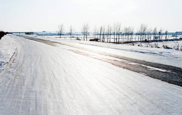 Highway through the field in winter.