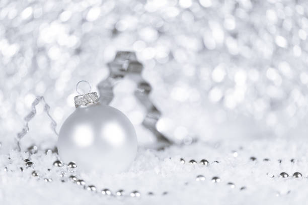 istock Fir tree cutter, bauble and pearls in color white and silver, snowflakes in the front 1179743250