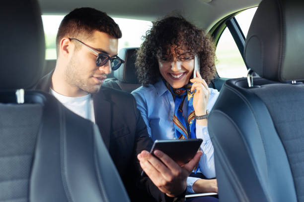 istock Business colleagues working on digital tablet in vehicle 1179744153