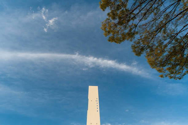 istock White tower and curved clouds and trees 1179747893