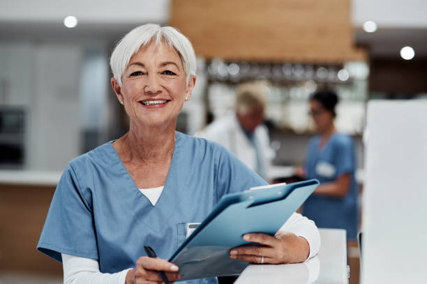 your health is always first on the agenda - senior adult hospital uniform gray hair imagens e fotografias de stock